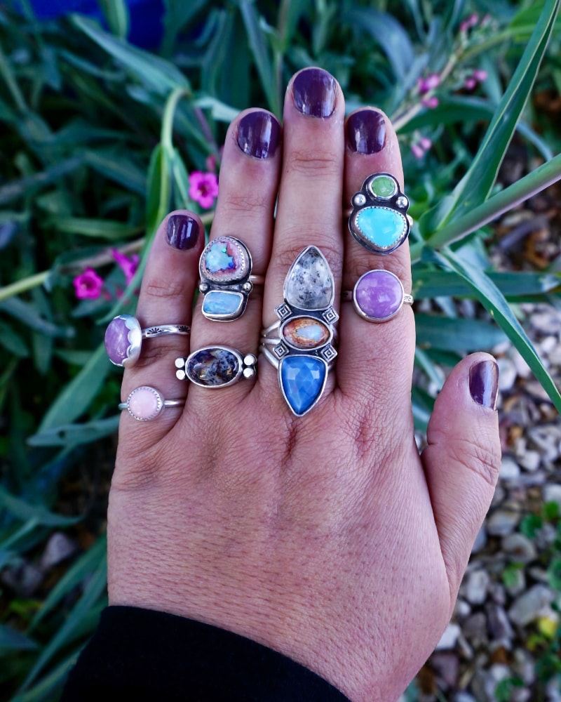 colorful turquoise opal rings on hand