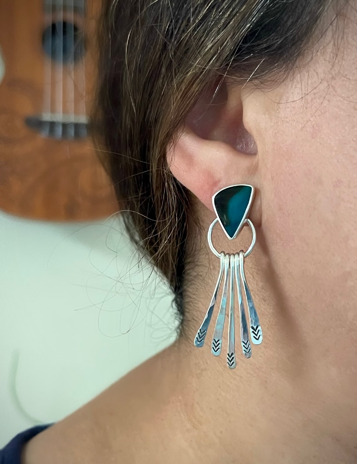 Blue opalized petrified wood sterling silver dangle fringe earrings shown worn on the ear