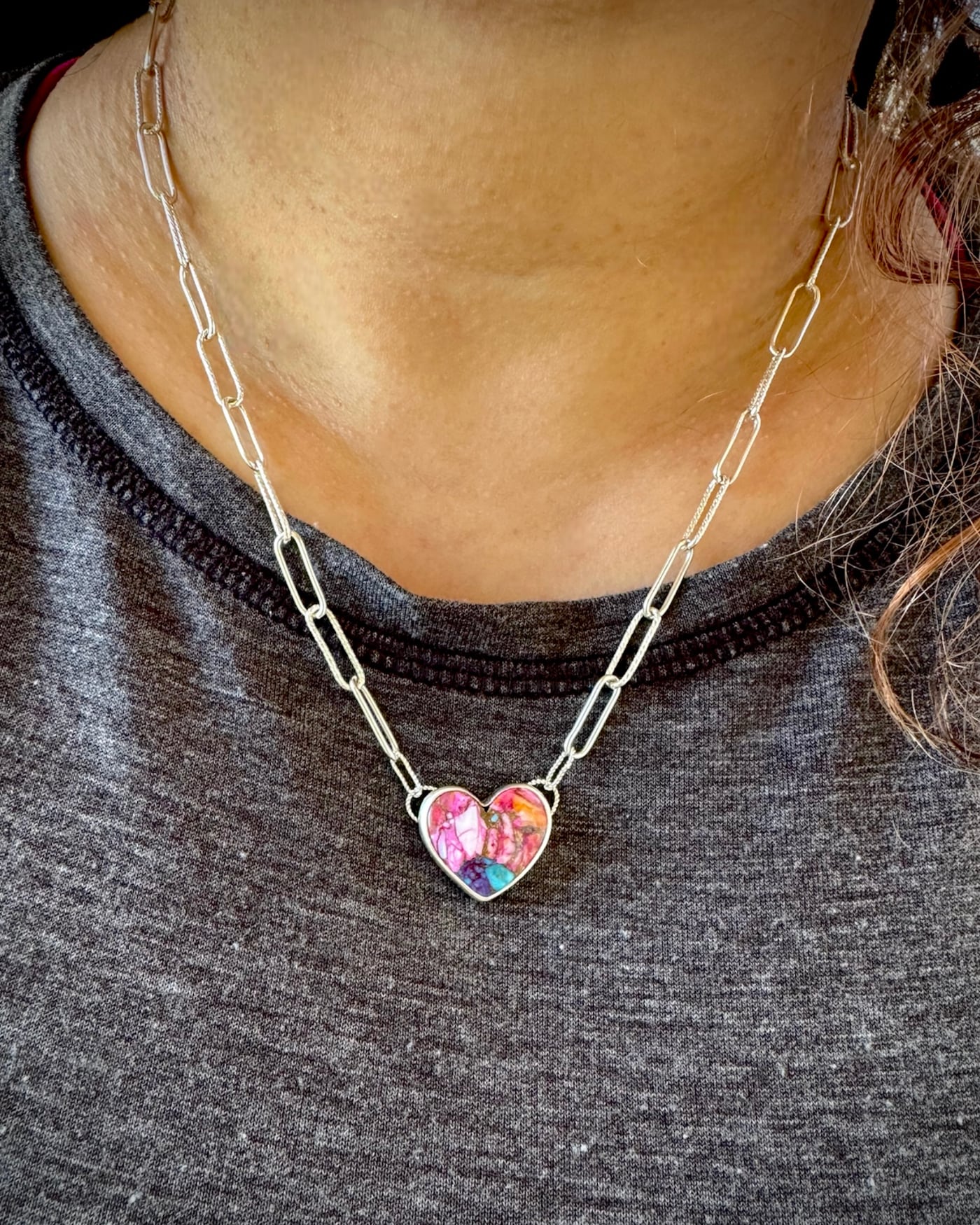 Handmade paperclip chain with a heart shaped stone pendant necklace shown worn.