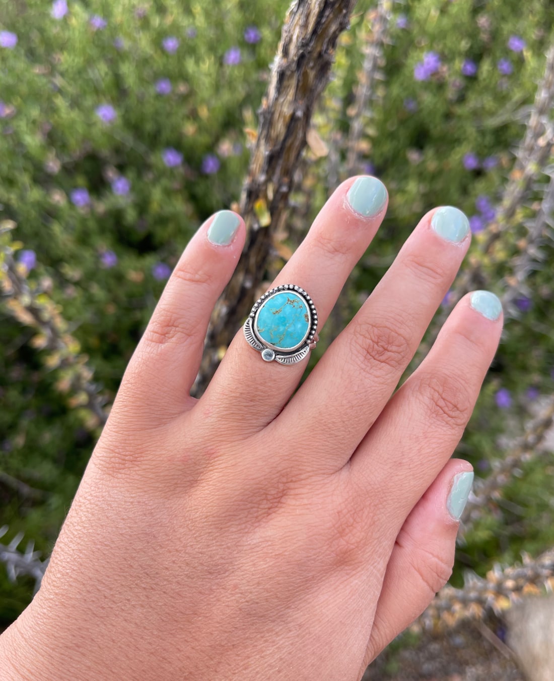 Number 8 turquoise sterling silver handmade ring shown worn on the hand