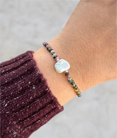 Tourmaline gemstone and pearl bracelet worn on wrist