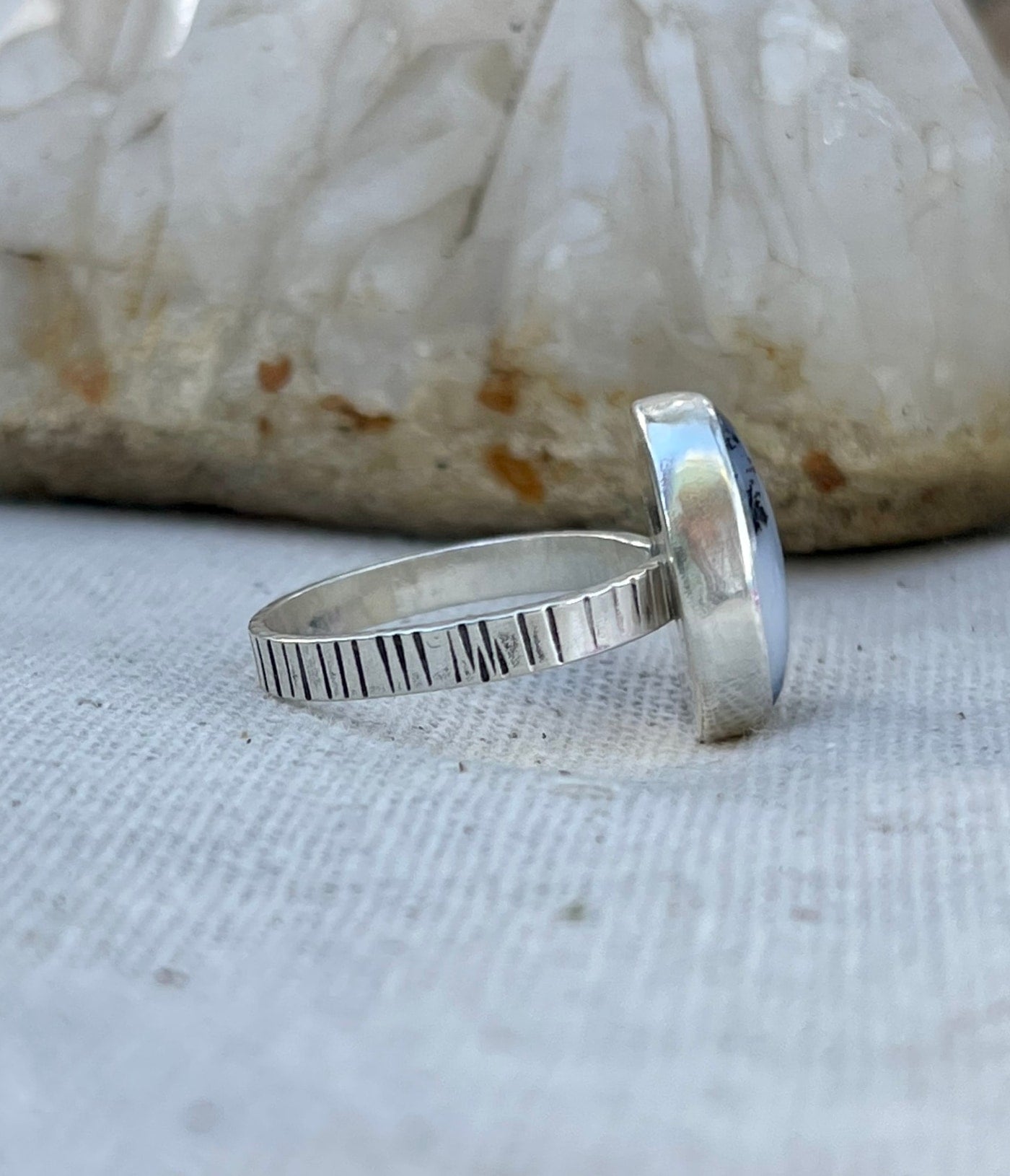 side band view of dendritic agate sterling ring, with line stamping detail on band