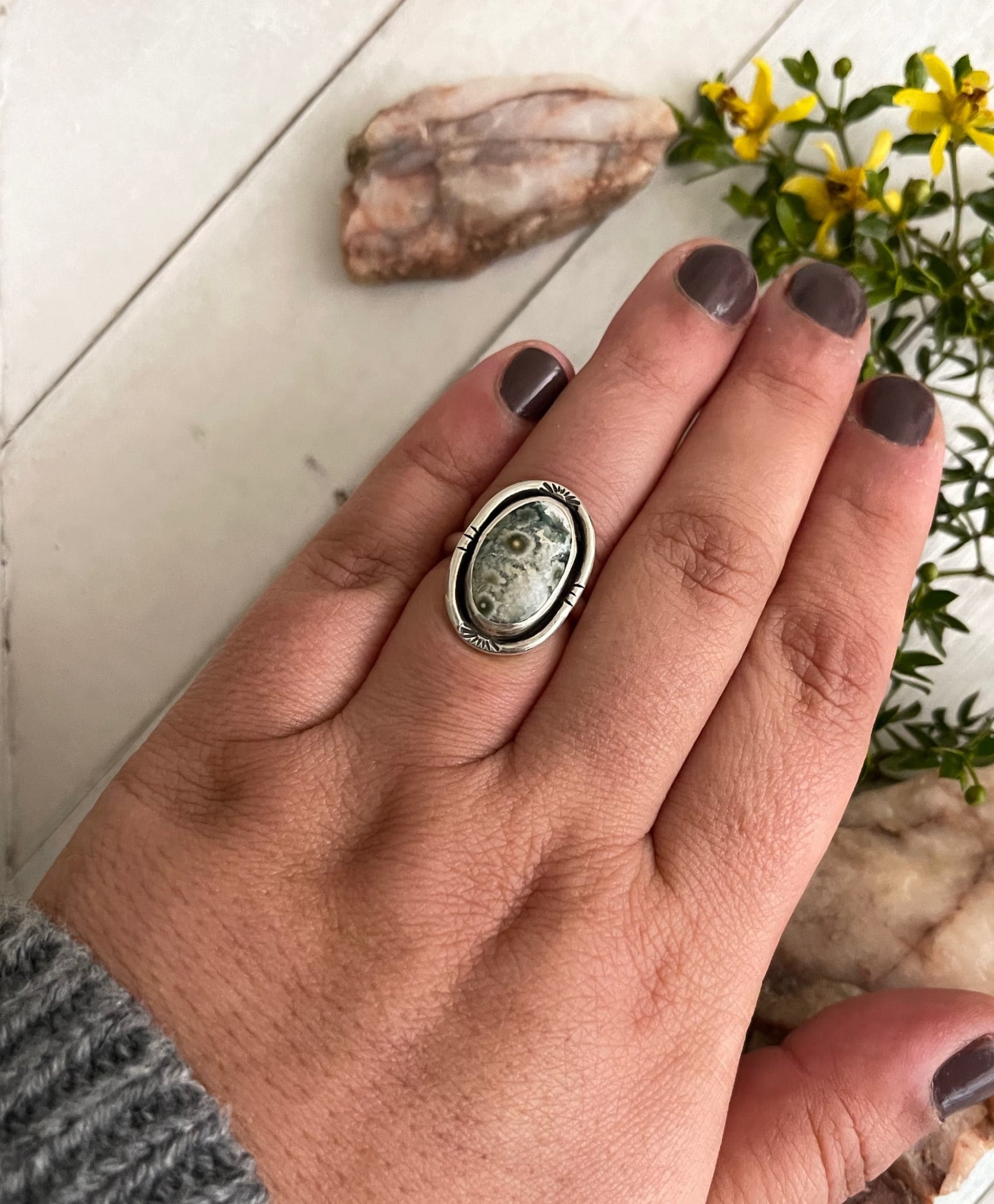 green ocean jasper ring with sterling handstamped wire border on sterling band size 7.25 shown on hand