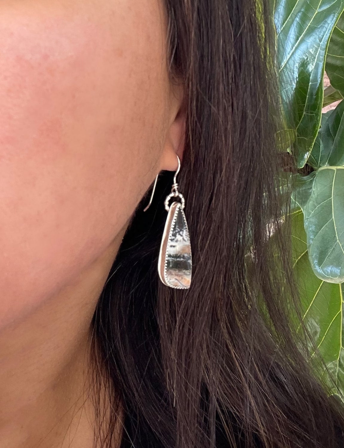 opalized petrified wood teardrop shaped dangle earrings shown in ear