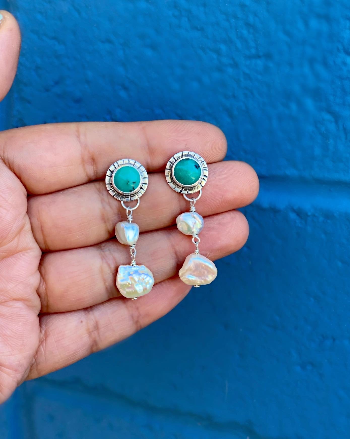 turquoise studs with handstamped lines around the bezel, with two organic shaped freshwater pearls hanging.